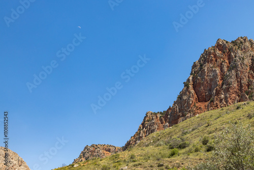 Monastery amid stunning red rocks and lush greenery showcases Armenias natural beauty.