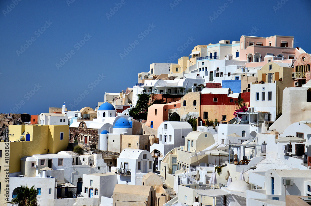 Beautiful summer view from Oia village in Santorini island, Greece at daytime. Beautiful summer view from Oia village in Santorini island, Greece at daytime.