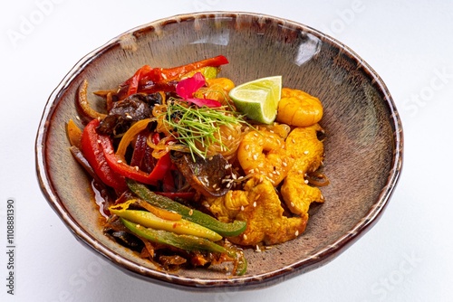 Pan-Asian Dish with Shrimp, Meat, Bell Peppers, Vegetables, and Sesame on a White Background photo