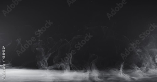 Abstract image of dark room concrete floor. Black room or stage background for product placement.Panoramic view of the abstract fog. White cloudiness, mist or smog moves on black background. 