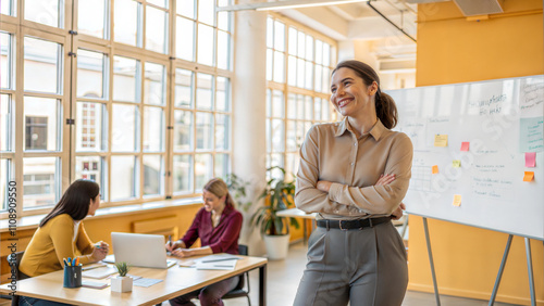 Portrait of smiling businesswoman standing with arms crossed at workplace in office