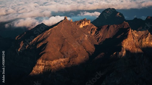 Wallpaper Mural Aerial hyperlapse of sunlight revealing a scenic mountain summit in Madeira during sunrise with clouds in the background Torontodigital.ca