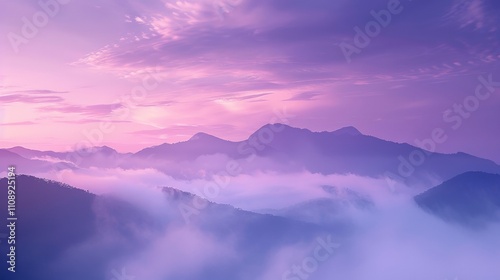 The sky is a beautiful shade of purple with clouds floating above. The mountains in the background are covered in fog, creating a serene and peaceful atmosphere
