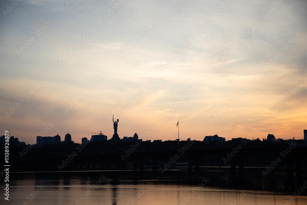 Beautiful view of the Mother Ukraine monument Paton Bridge on the Dnipro river in Kyiv, Ukraine