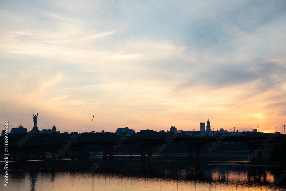 Beautiful view of the Mother Ukraine monument Paton Bridge on the Dnipro river in Kyiv, Ukraine