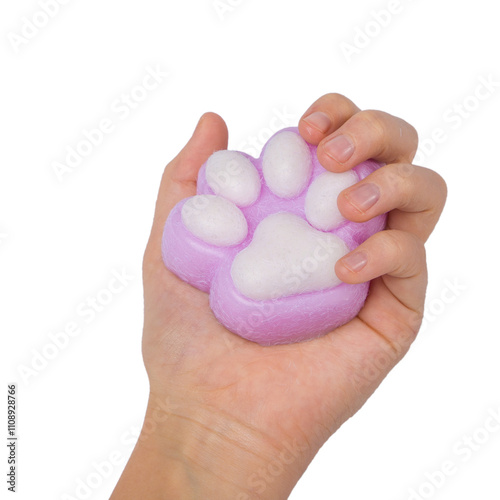 Pink toy cat paw in the hand isolated on a white background. Decompression squeeze toy. photo