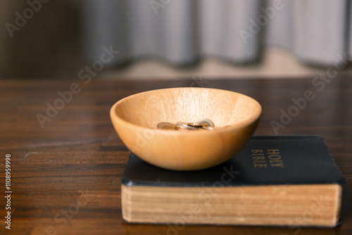 Idea of giving tithe as an offering to charity filled him with hope and peace, as he donated money with faith in making positive impact. book, financial, believe, spiritual, currency, wealth, coin