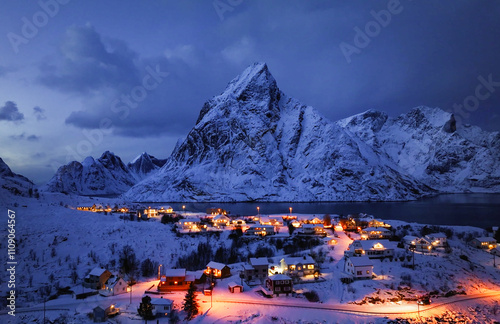 A stunning and breathtaking winter landscape featuring a mountain and bright village lights photo