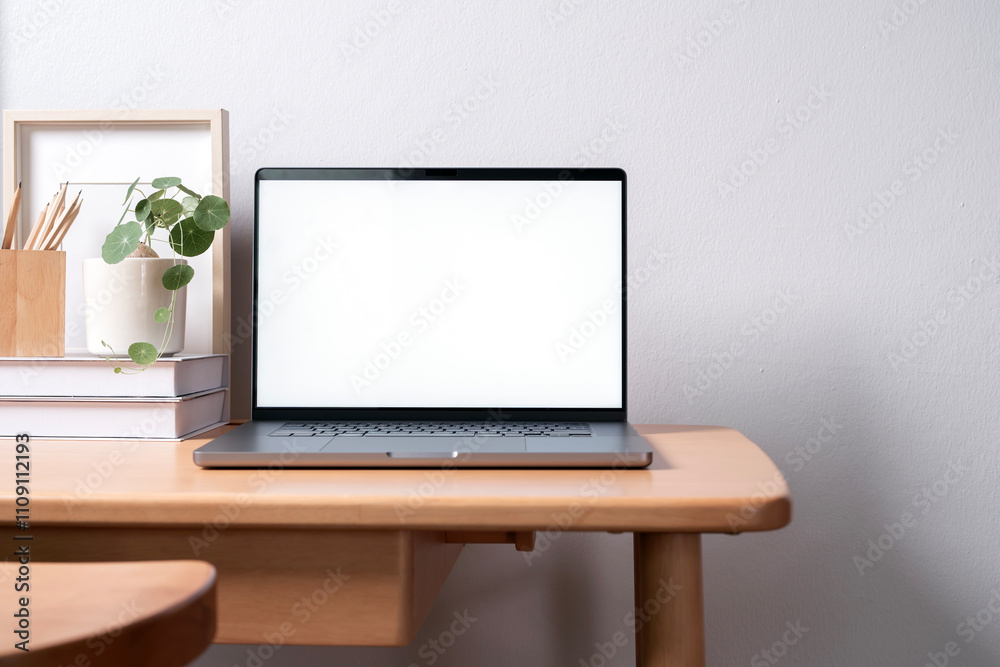 Fototapeta premium Open laptop with blank screen on a wooden desk in a home office