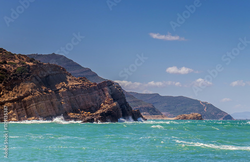 Deserted Haven: Ain Kanassira's Beach Nestled Between Sea and Mountains in Tunisia photo