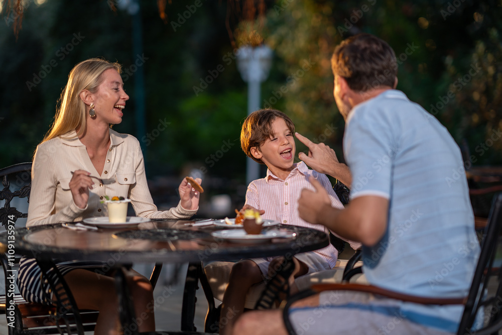 A cheerful family spending quality time at a cozy cafe, sharing laughter and enjoying delicious treats in a warm and inviting atmosphere. A cheerful family spending quality time at a cozy cafe, sharing laughter and enjoying delicious treats in a warm and inviting atmosphere.