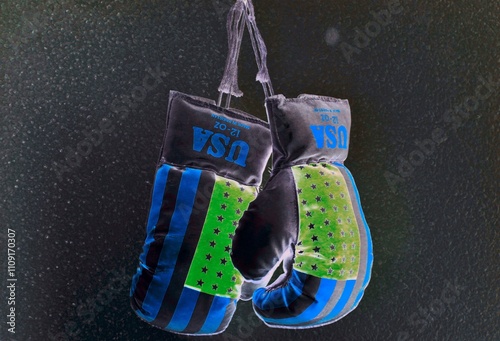 boxing gloves for fighter with the USA blue and green flag hung on the wall

