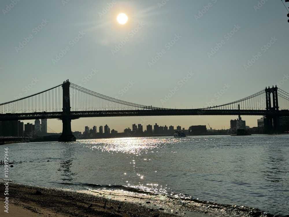 Fototapeta premium On a sandy beach with the Manhattan Bridge in the background Manhattan, New York, NY, USA