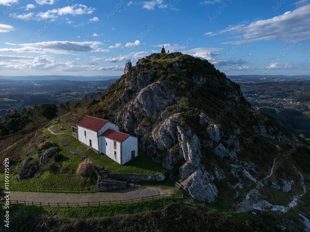 Obraz premium Aerial view of the Pico Sacro mountain and the Chapel of San Sebastian del Pico Sacro in Boqueixon, Galicia