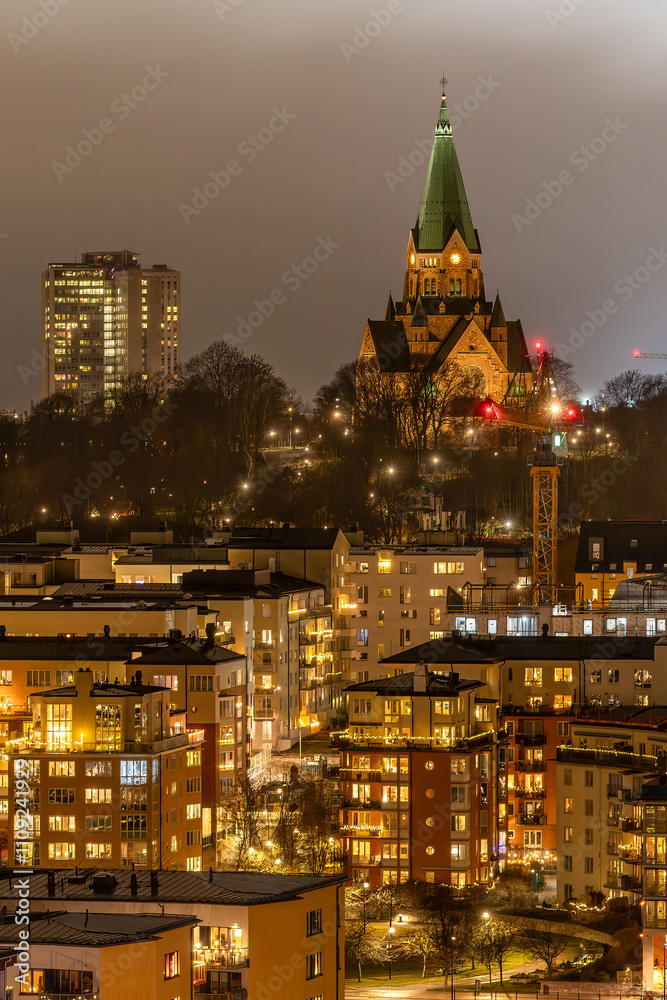 Fototapeta premium Stockholm, Sweden A night view of Sodermalm apartment buildings and the Sofia Church.