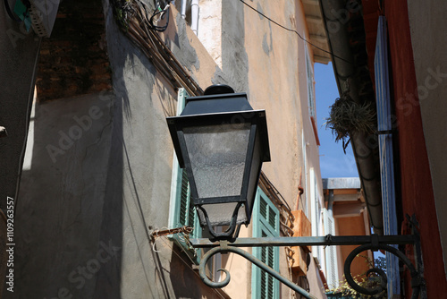 Lamp post in a narrow street in the city of Menton, French Riviera.