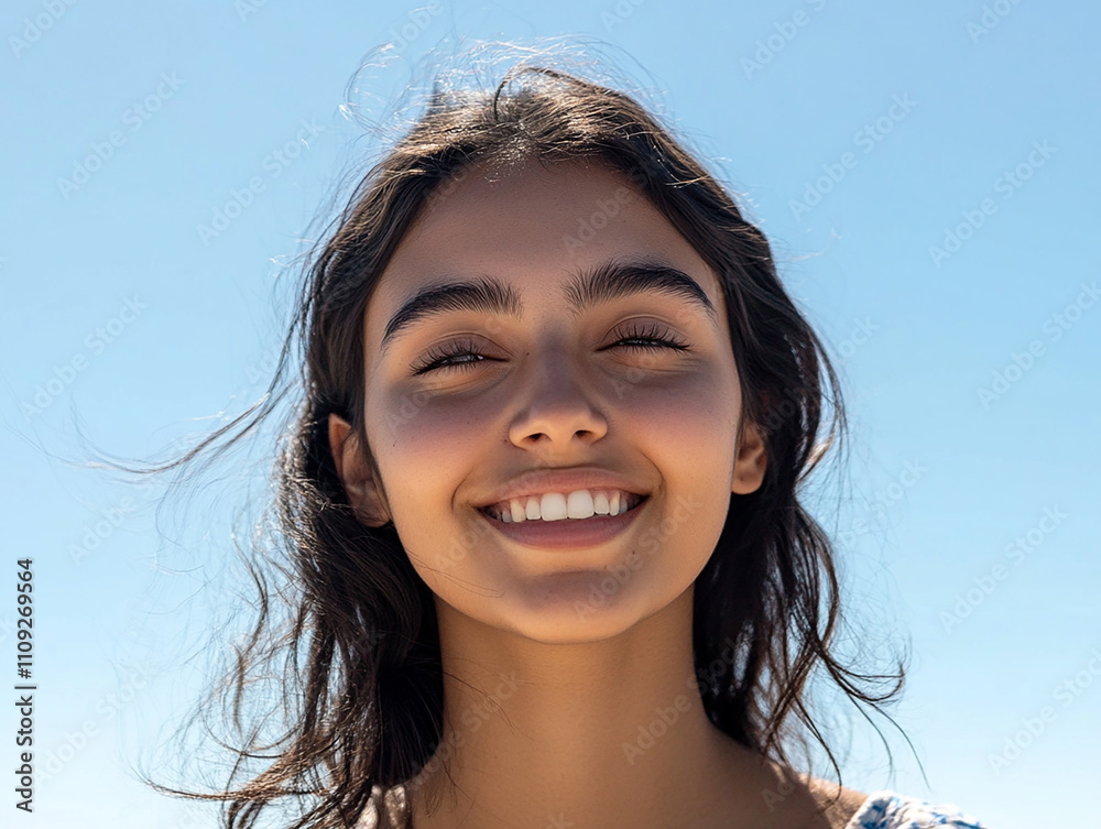 Close-up photo of beautiful woman against blue sky background Close-up photo of beautiful woman against blue sky background