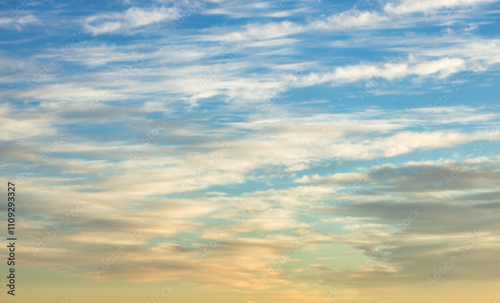 Obraz premium A beautiful sky tinted by the sun leaving vibrant shades of gold, pink, blue and multicolored. Clouds in the twilight evening and morning sky. Cloudy sky background in the evening, and during the day.