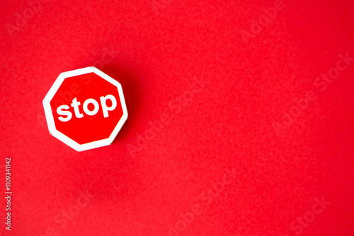 Stop sign on red paper background; warning sign, Dangerous alert photo