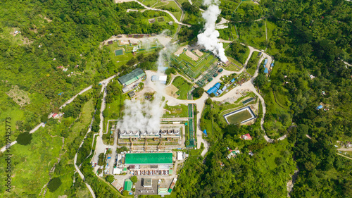 Aerial view of geothermal power plant with smoking pipes and steam. Renewable energy production at a power station. Negros, Philippines.