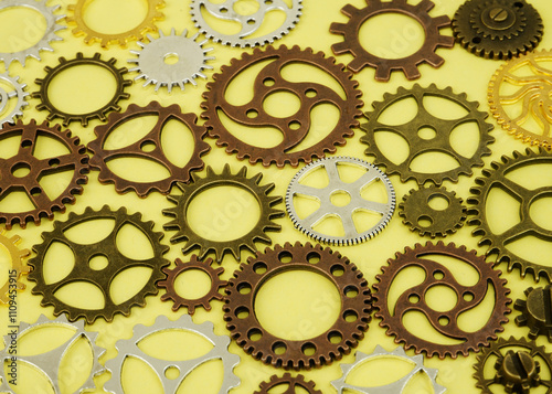 Connected steampunk gears on yellow background photo