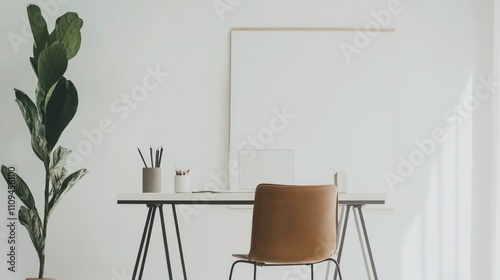 Minimalist home office interior with a fiddle leaf fig plant, a tan leather chair, and a blank canvas.