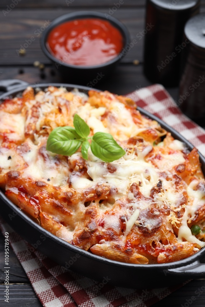 Delicious al forno pasta in baking dish on wooden table, closeup Delicious al forno pasta in baking dish on wooden table, closeup