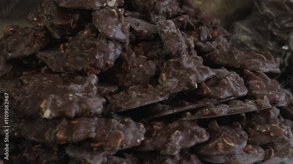 Homemade chocolate clusters with nuts on display at a local market Homemade chocolate clusters with nuts on display at a local market