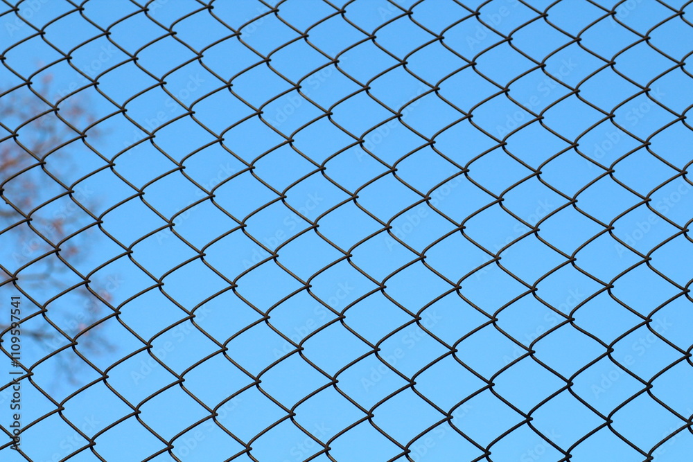 Metal fence texture with blue sky background Metal fence texture with blue sky background
