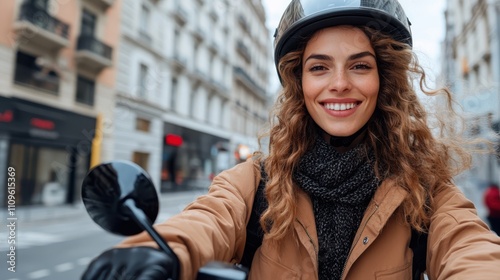 A cheerful woman in a helmet and scarf rides her scooter through the city's bustling streets, highlighting a sense of freedom and adventure in urban life. photo