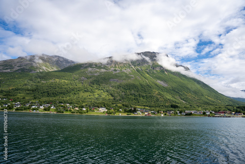 Green mountains, fjord and blue sky in Norwegian landscape in Olderdalen, Norway photo