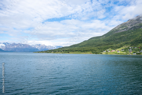 Green mountains, fjord and blue sky in Norwegian landscape in Olderdalen, Norway photo