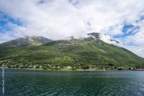 Green mountains, fjord and blue sky in Norwegian landscape in Olderdalen, Norway photo