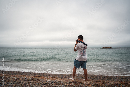 man taking a photo on the beach