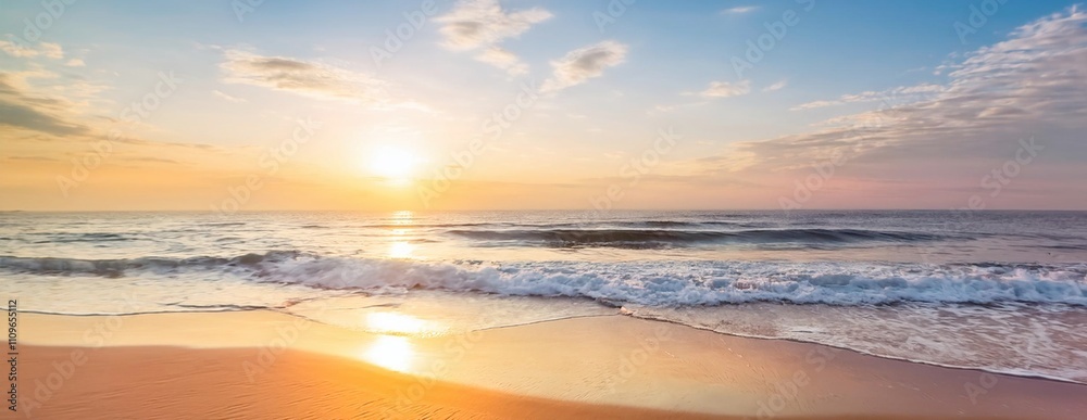 Fototapeta premium Golden hour paints the sky with vibrant hues as the sun dips below the horizon, casting its warm glow over the tranquil ocean and sandy shores
