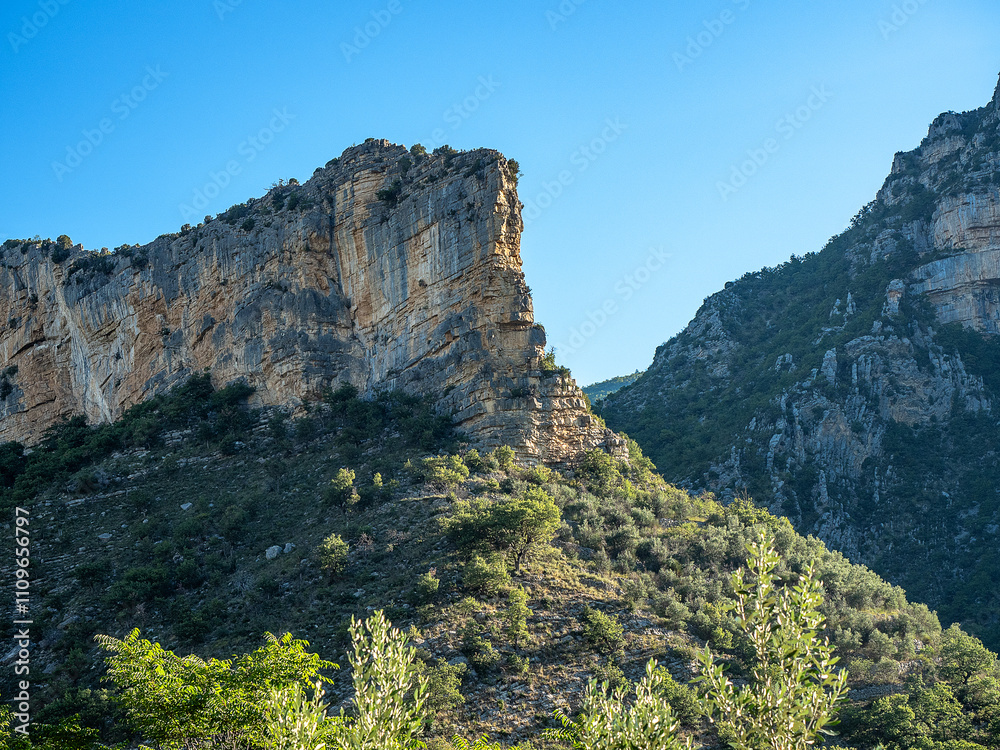 Rocky outcrop with horizontal striped structure, silhouetted against an intensely blue sky Rocky outcrop with horizontal striped structure, silhouetted against an intensely blue sky