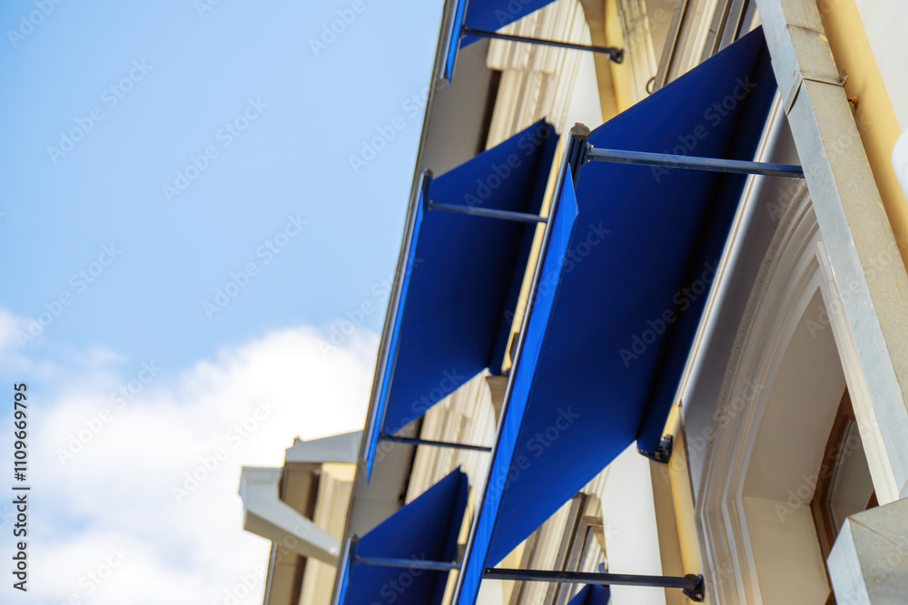 custom made wallpaper toronto digitalretractable blue fabric awnings adorning windows, creating a vibrant contrast against the building's facade, enhancing both aesthetics and functionality