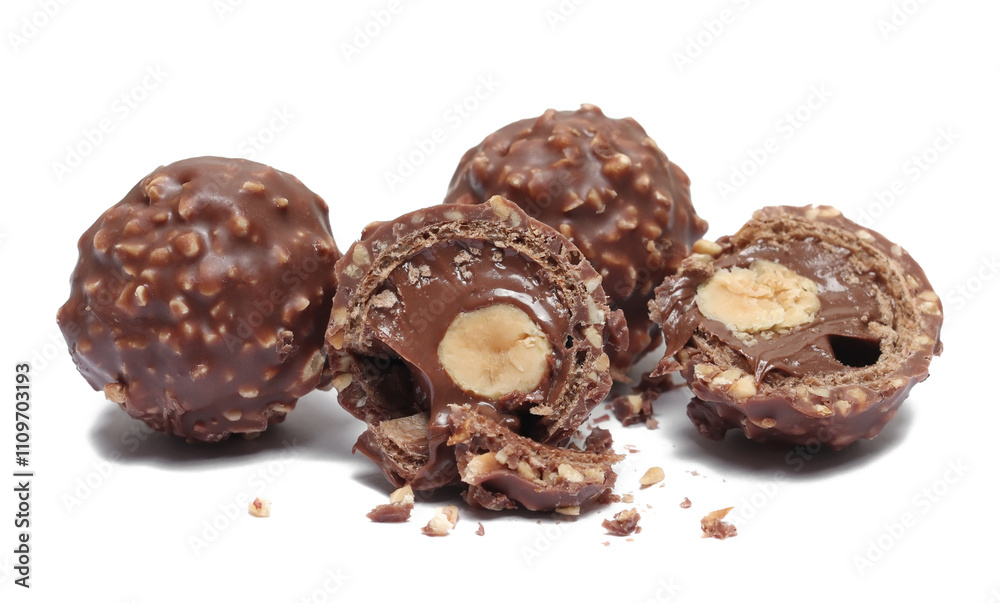 Chocolate balls and half with hazelnut isolated on white, top view Chocolate balls and half with hazelnut isolated on white, top view