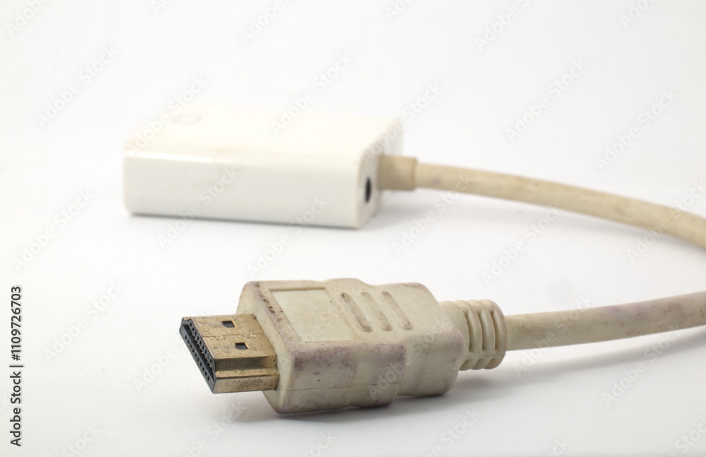 A tool to convert HDMI port to VGA port then go to a projector or monitor on a white background. A tool that is usually used when presenting in the office or meeting. A tool to convert HDMI port to VGA port then go to a projector or monitor on a white background. A tool that is usually used when presenting in the office or meeting.