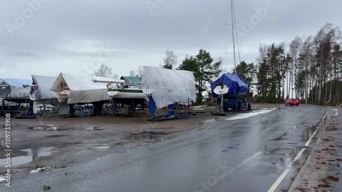 A Rainy Day at the Boat Storage Yard filled with moored boats under a cloudy sky
