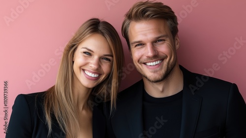 Smiling caucasian young adult couple posing against pink background