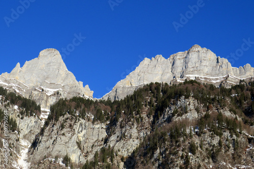 Steep rocky peaks of the Churfirsten mountain range, above Lake Walensee and the Swiss town of Walenstadtberg (Die steilen Felsgipfel der Churfirstengruppe oberhalb des Walensees, Schweiz) photo