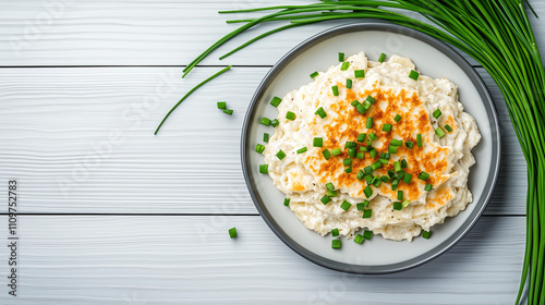 A hearty serving of ksesptzle topped with crispy golden bits and fresh chives photo