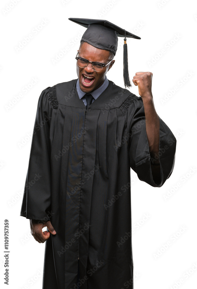 Young graduated african american man over isolated background angry and mad raising fist frustrated and furious while shouting with anger. Rage and aggressive concept. Young graduated african american man over isolated background angry and mad raising fist frustrated and furious while shouting with anger. Rage and aggressive concept.