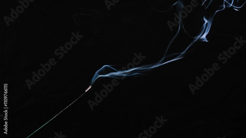dance of incense smoke with light in the dark