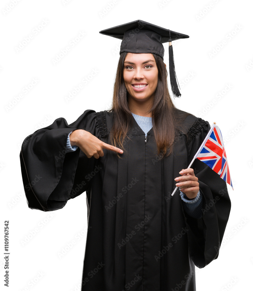 Young hispanic woman wearing graduated uniform holding flag of united kingdom with surprise face pointing finger to himself Young hispanic woman wearing graduated uniform holding flag of united kingdom with surprise face pointing finger to himself