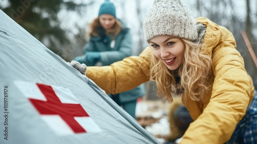 Volunteers Collaborate to Set up a First Aid Tent for Disaster Relief Efforts in a Winter Environment photo