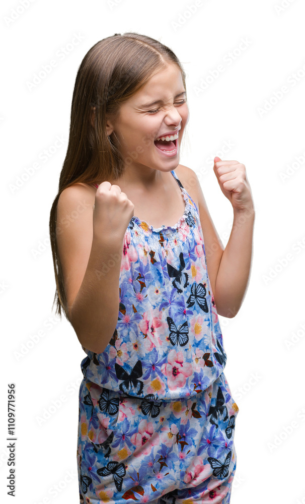 Young beautiful girl wearing colorful dress over isolated background very happy and excited doing winner gesture with arms raised, smiling and screaming for success. Celebration concept. Young beautiful girl wearing colorful dress over isolated background very happy and excited doing winner gesture with arms raised, smiling and screaming for success. Celebration concept.