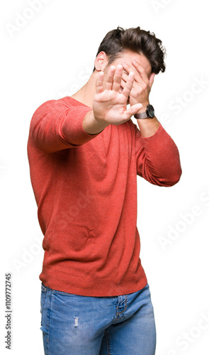 Young handsome man over isolated background covering eyes with hands and doing stop gesture with sad and fear expression. Embarrassed and negative concept.