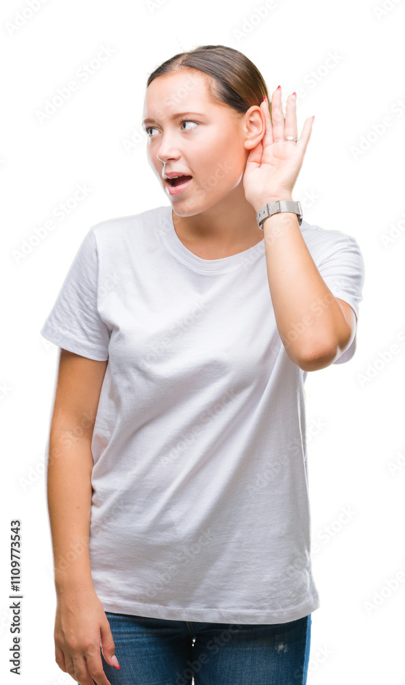 Young beautiful caucasian woman over isolated background smiling with hand over ear listening an hearing to rumor or gossip. Deafness concept.